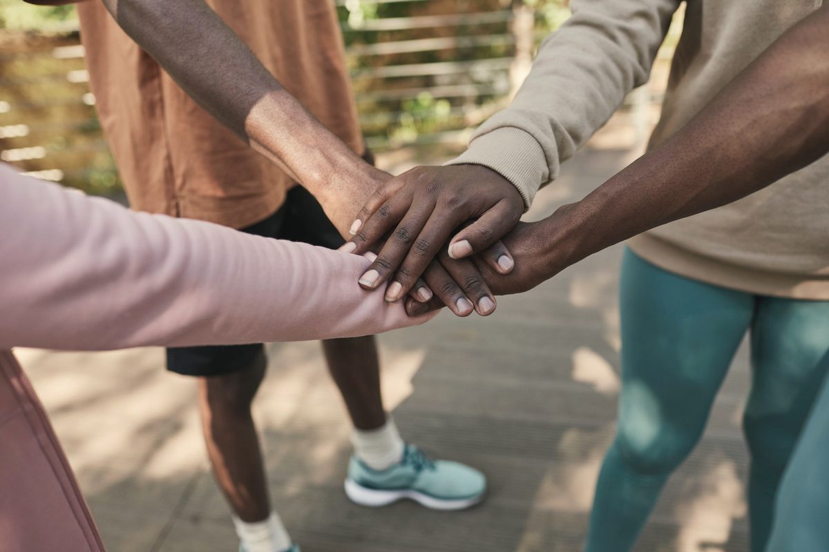 Group joining hands in a show of support