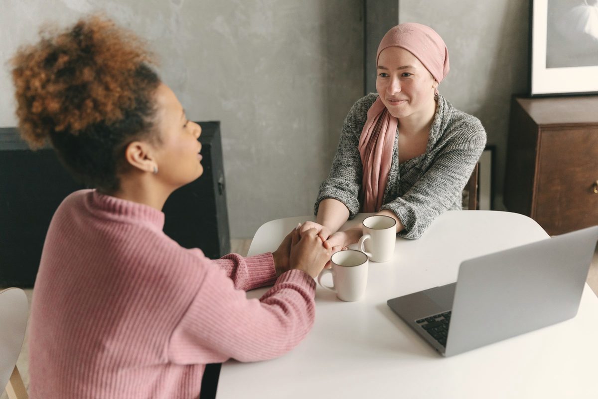 Woman holding hands with a friend for support