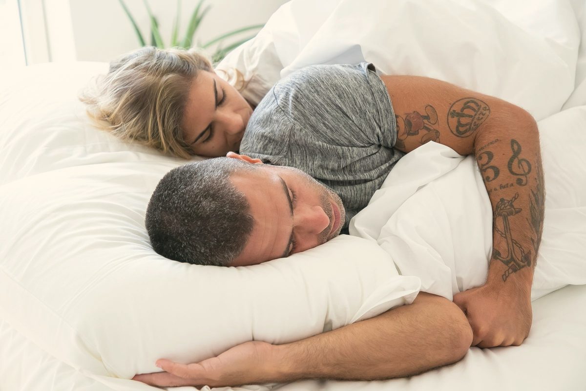 Couple sleeping on bed