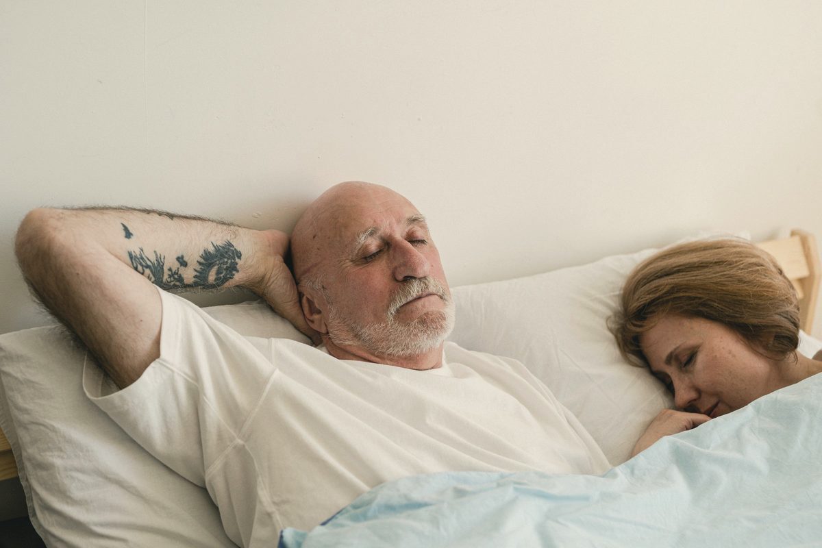A couple sleeping on the bed