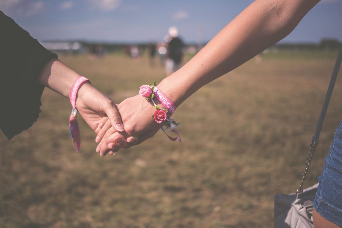 Two friends holding hands
