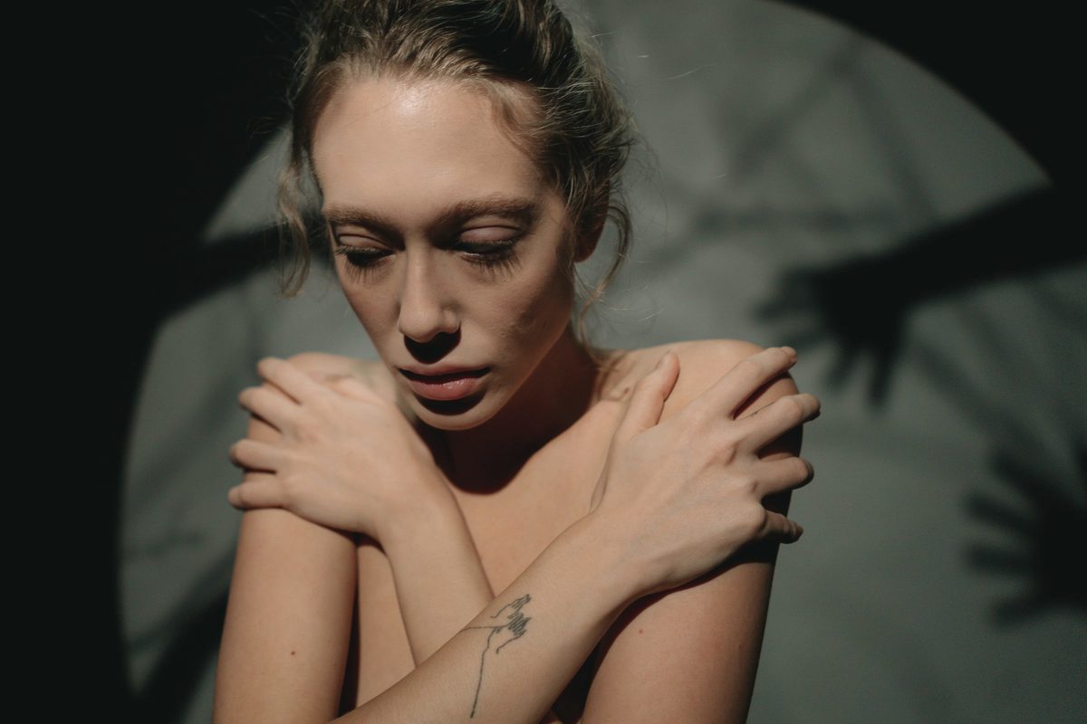 Woman hugging herself in a quiet moment