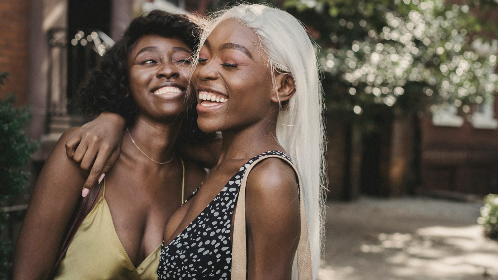Two women friends smiling and hugging each other