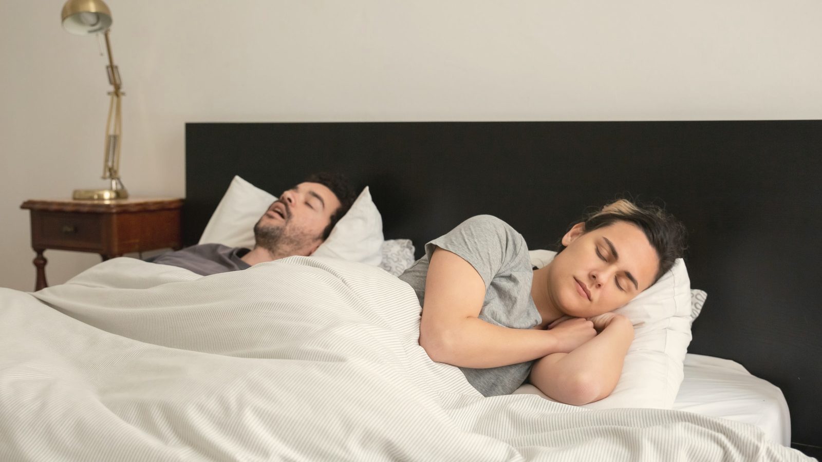 A couple sleeping in bed