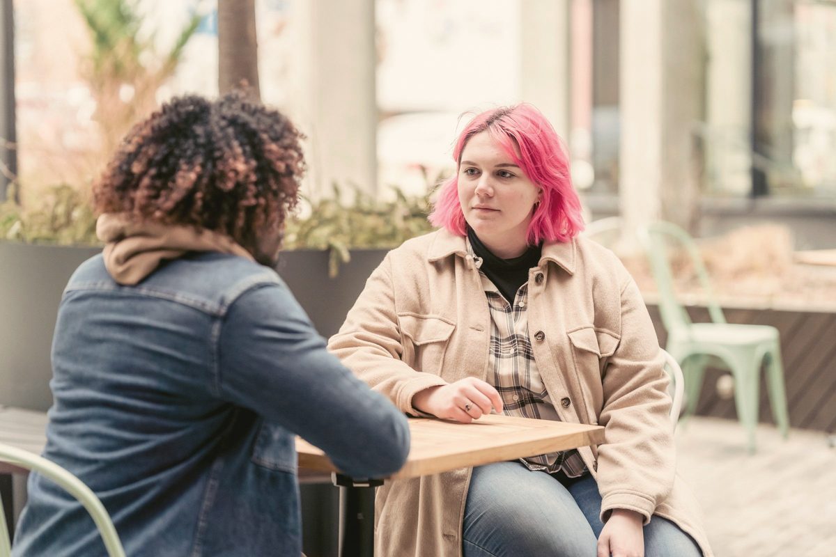 Friends chatting at a cafe table