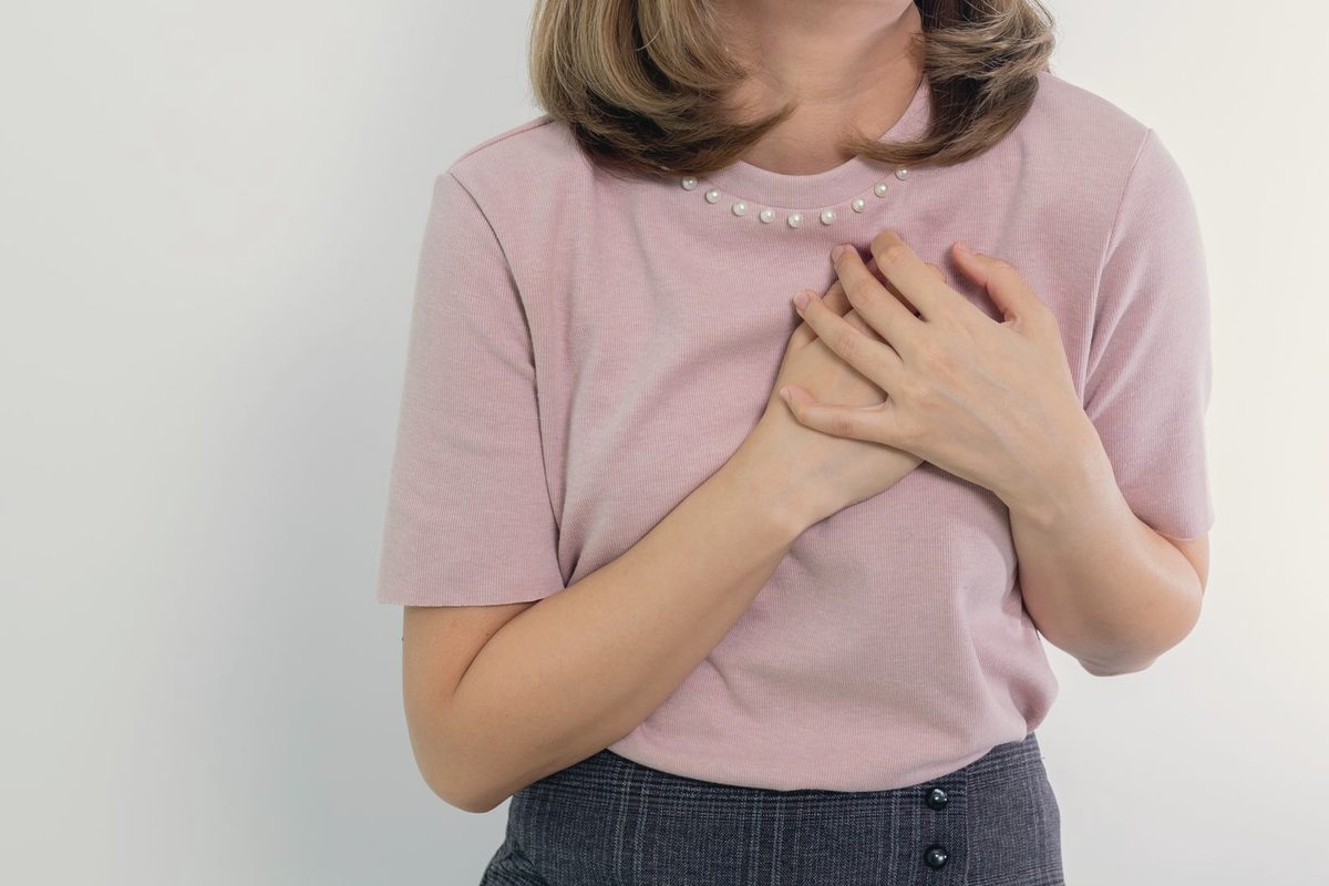 Woman holding hands on her chest
