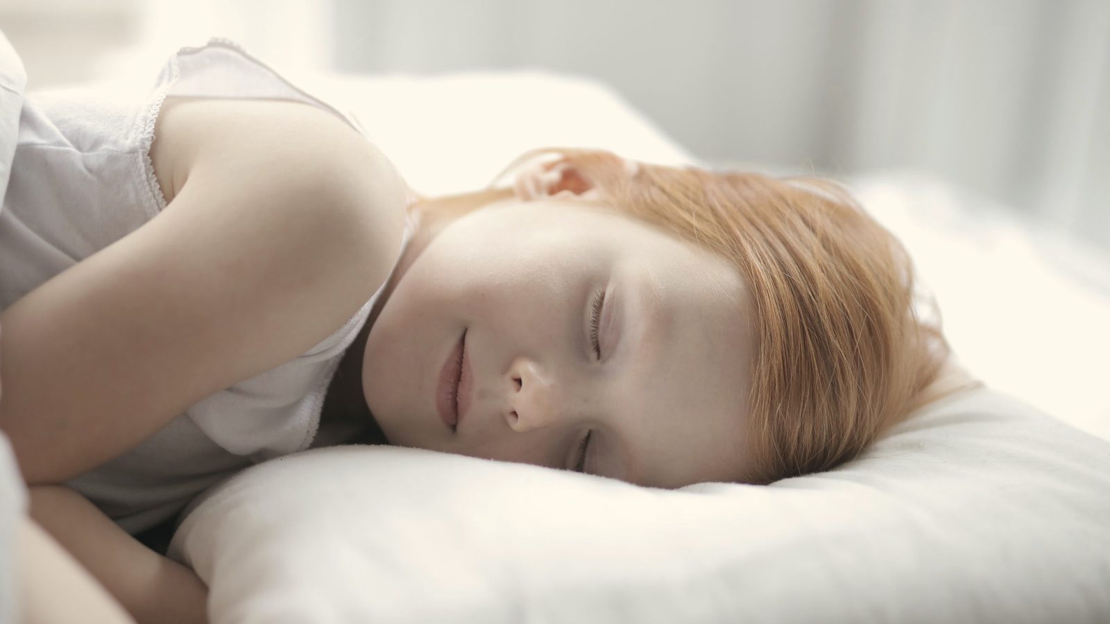 Young girl sleeping peacefully in bed