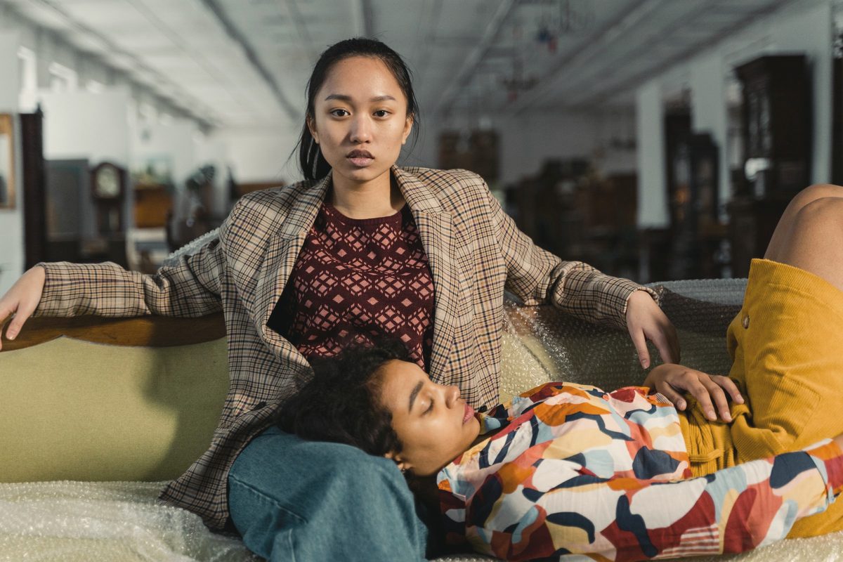 Two women unwinding together on a sofa