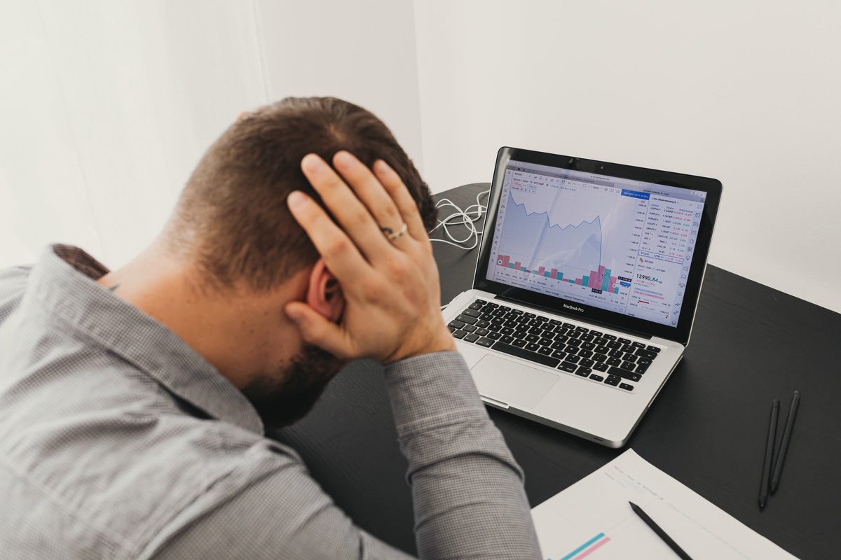 Stressed man looking at his laptop