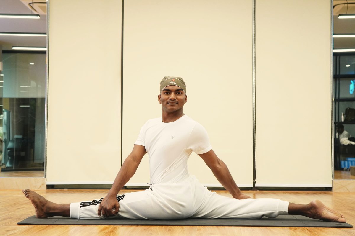 Man stretching his legs on a yoga mat