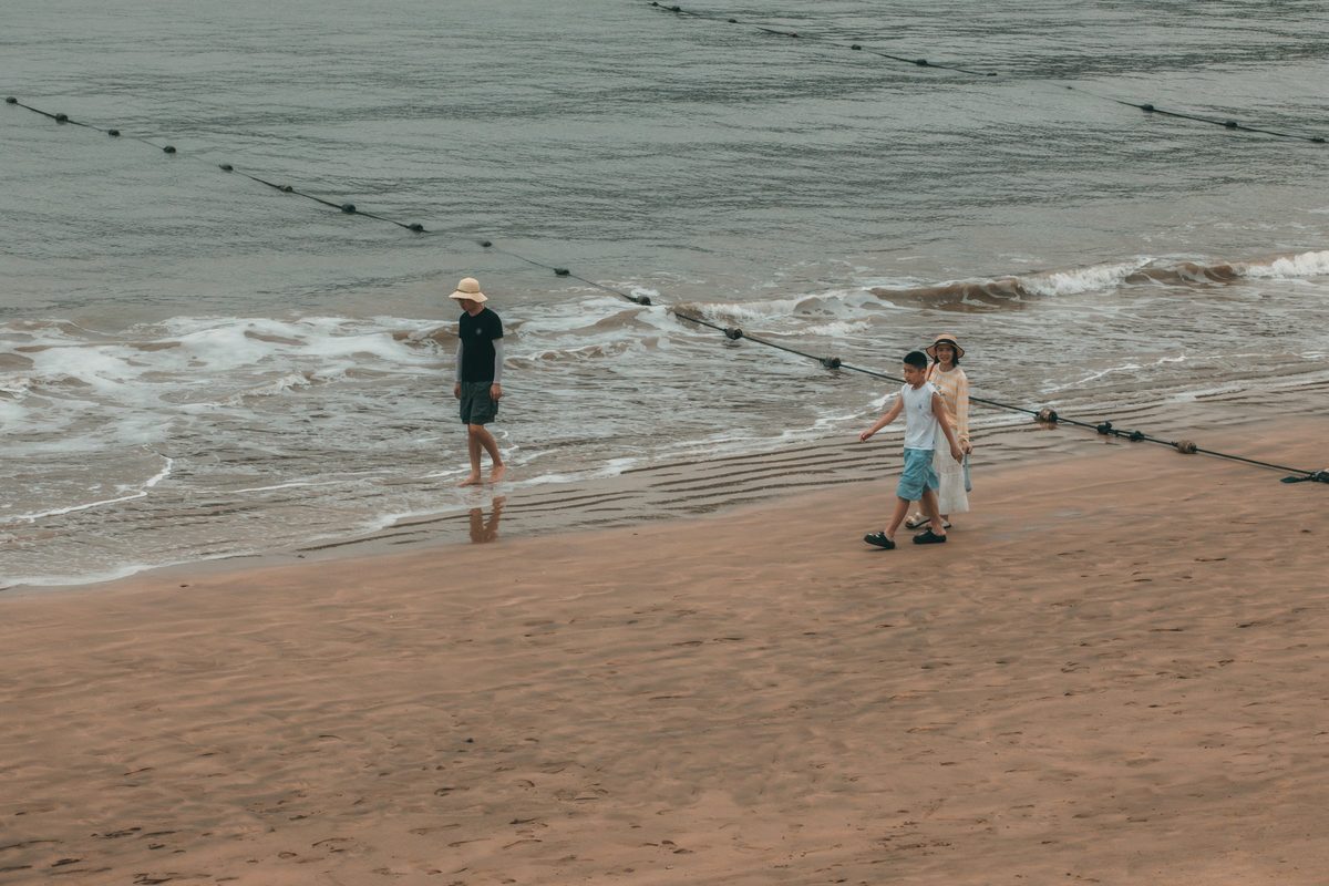 People walking on a tranquil sandy beach