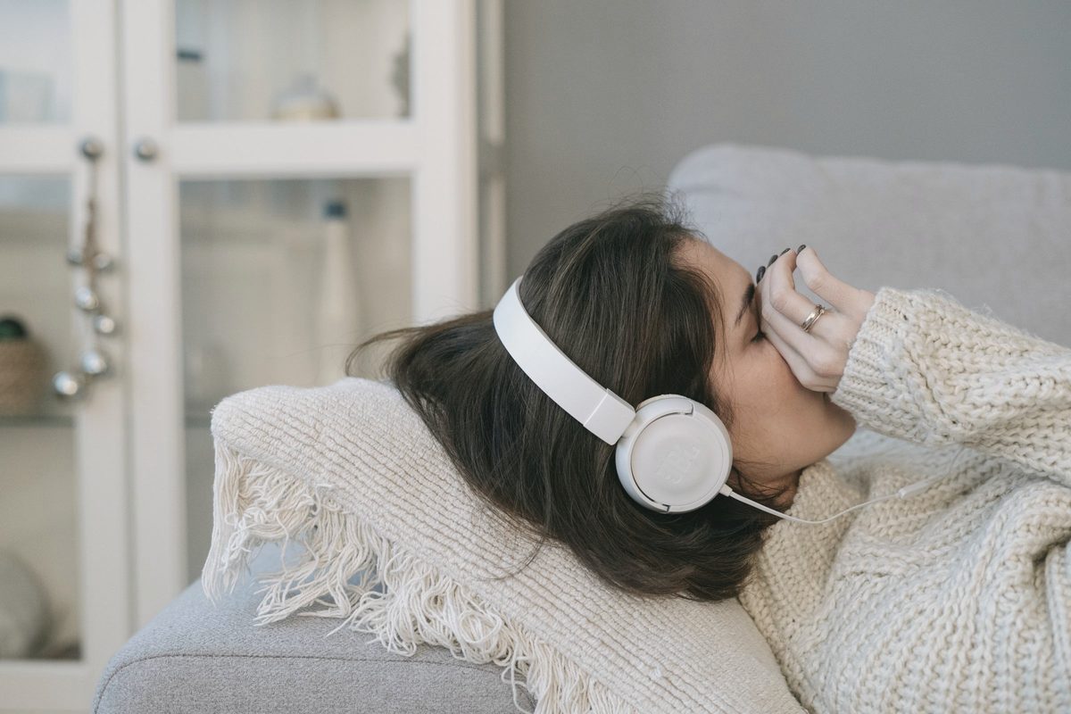 Woman relaxing on the sofa with headphones