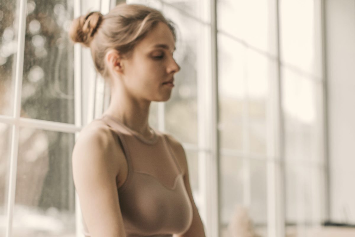 Woman sitting quietly by a sunny window