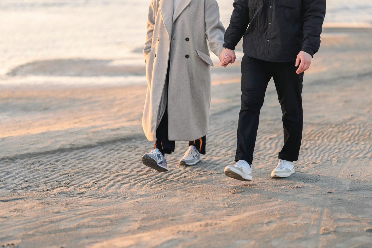 Couple walking together on the sand