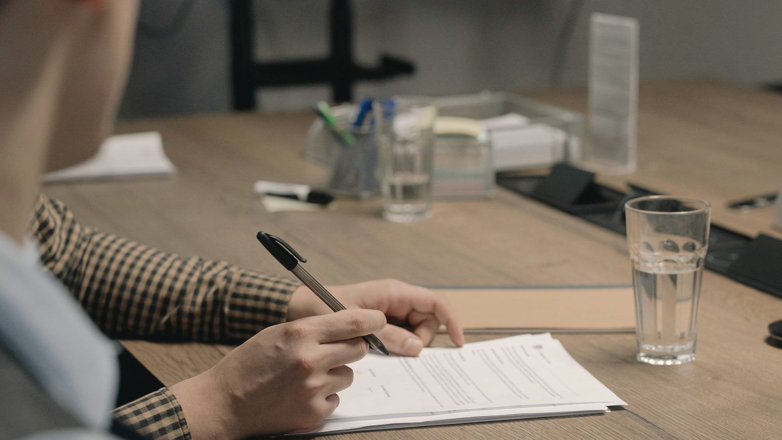 A person signing contract documents