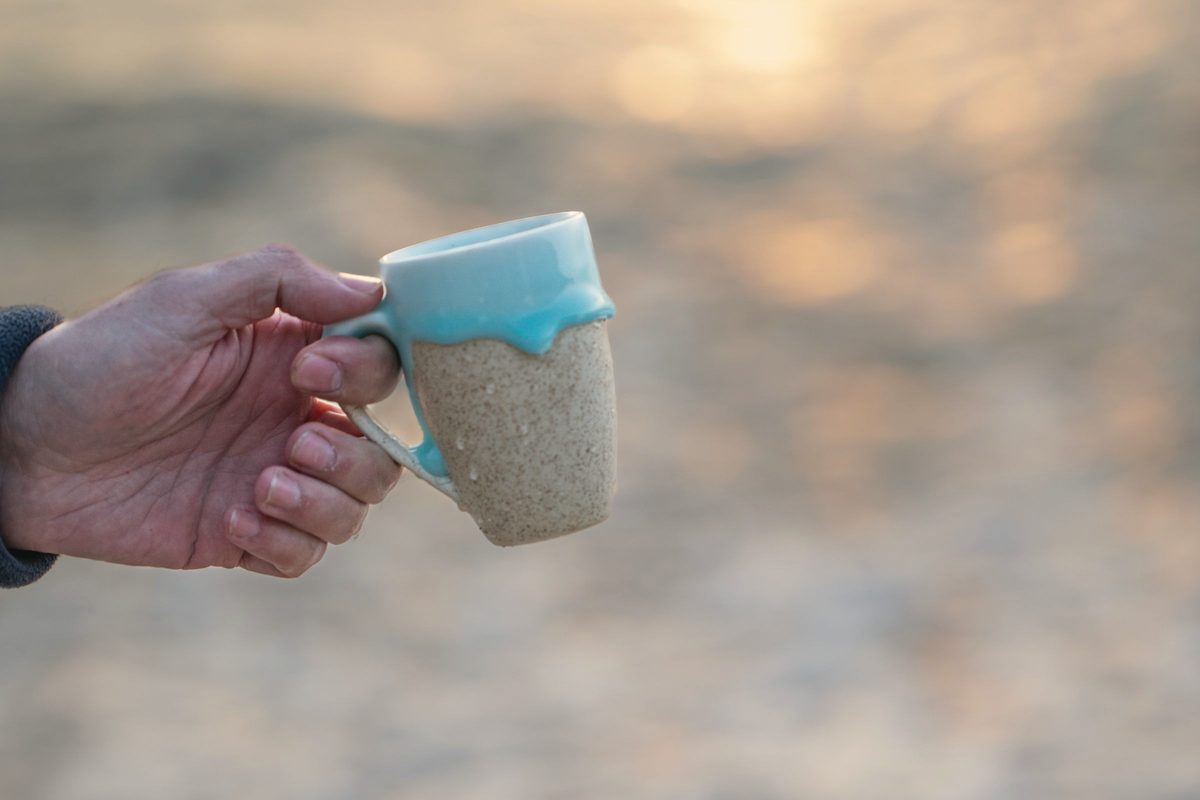 Morning coffee by the beach at sunrise