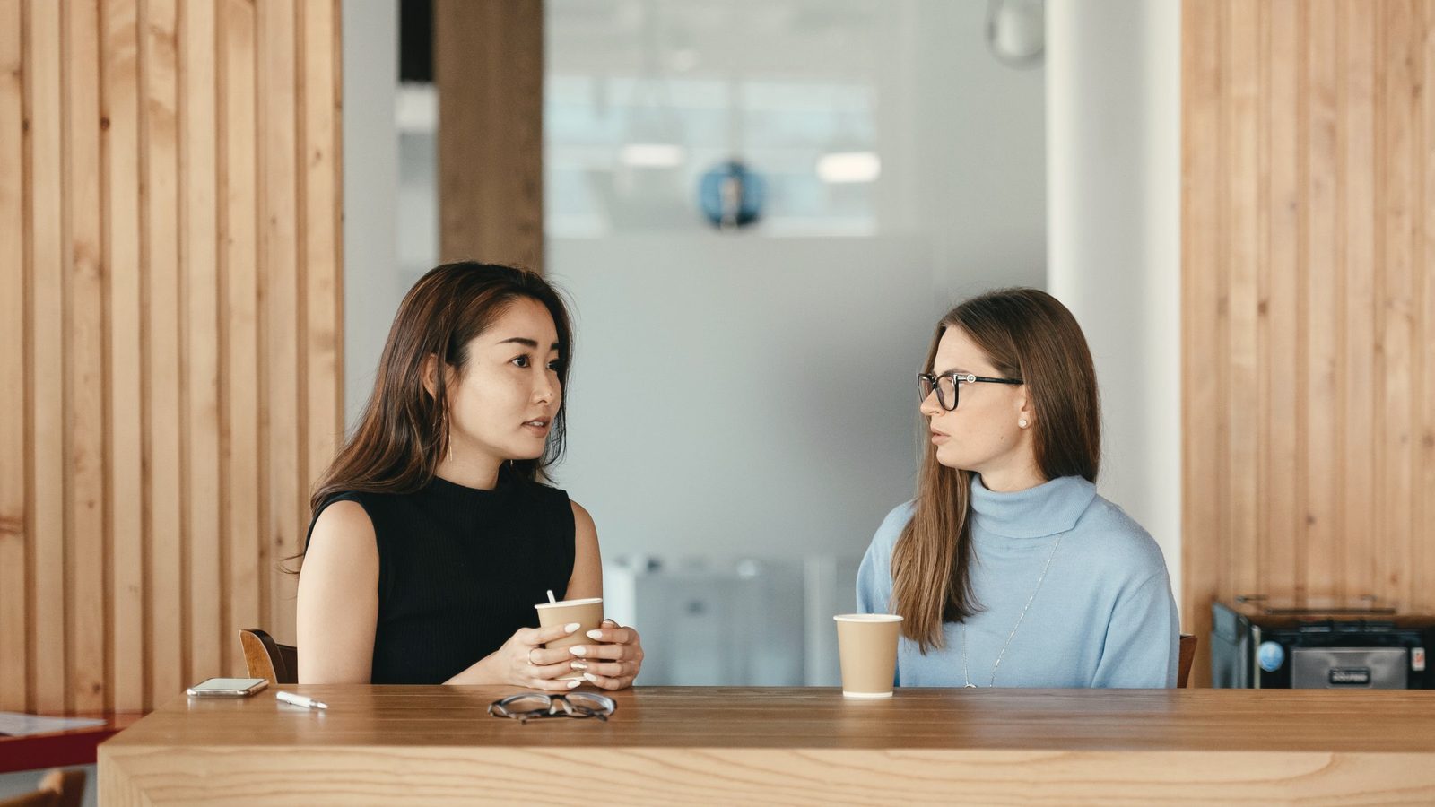 Women talking during a coffee break at a table