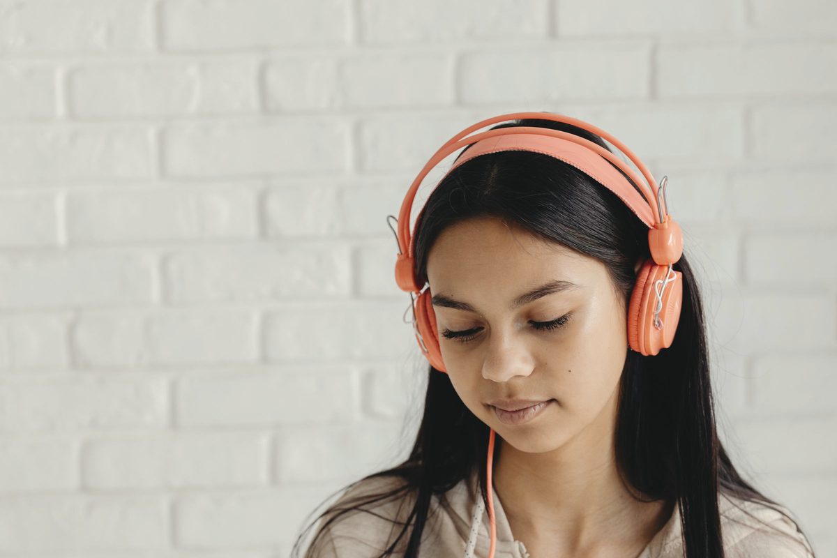 Girl with headphones and her eyes closed