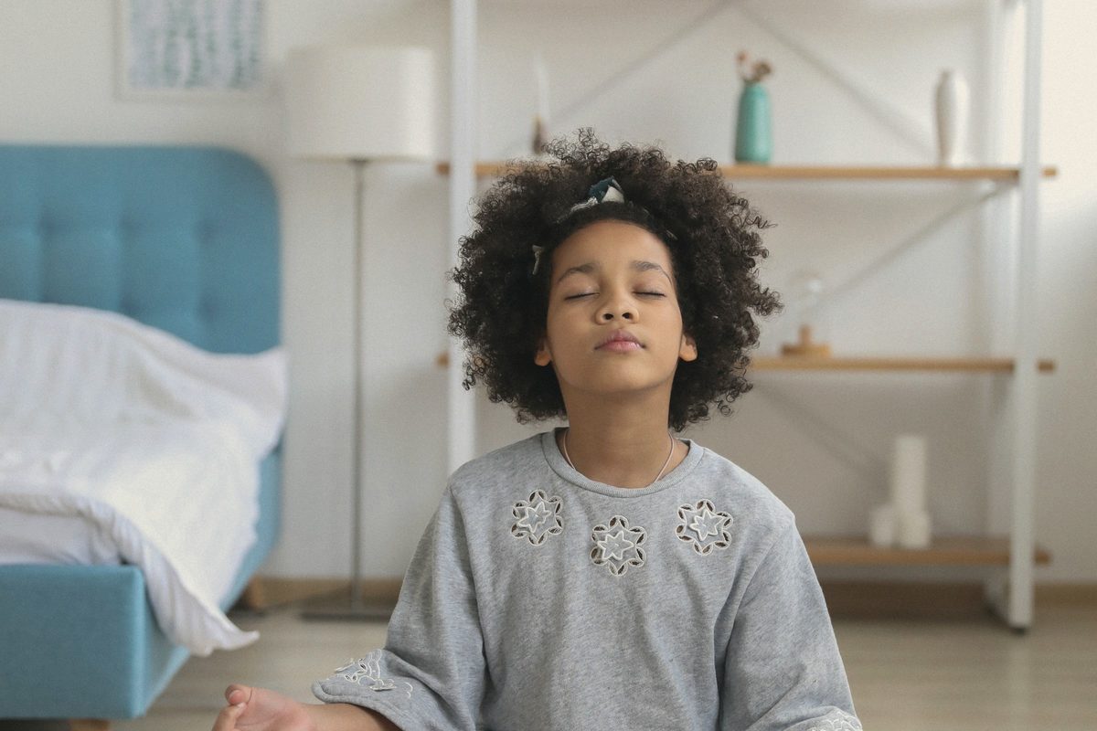 Young woman meditating with eyes closed