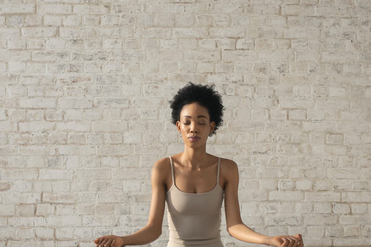 A woman sitting on a cushion meditating