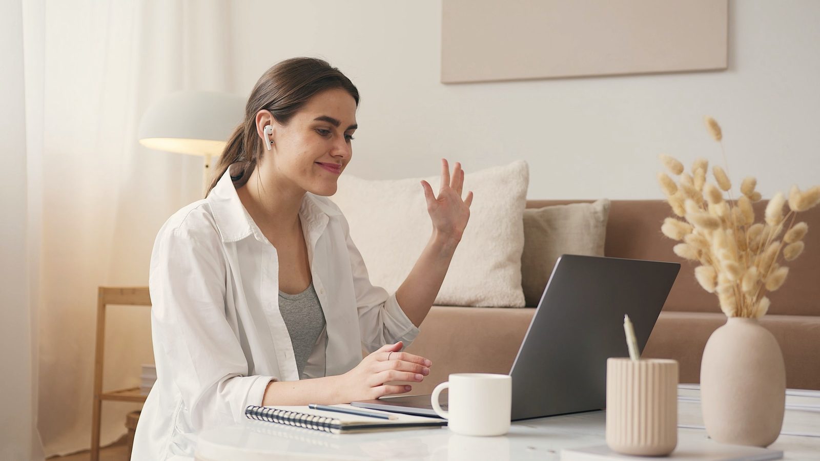 Cheerful woman having a video call via laptop